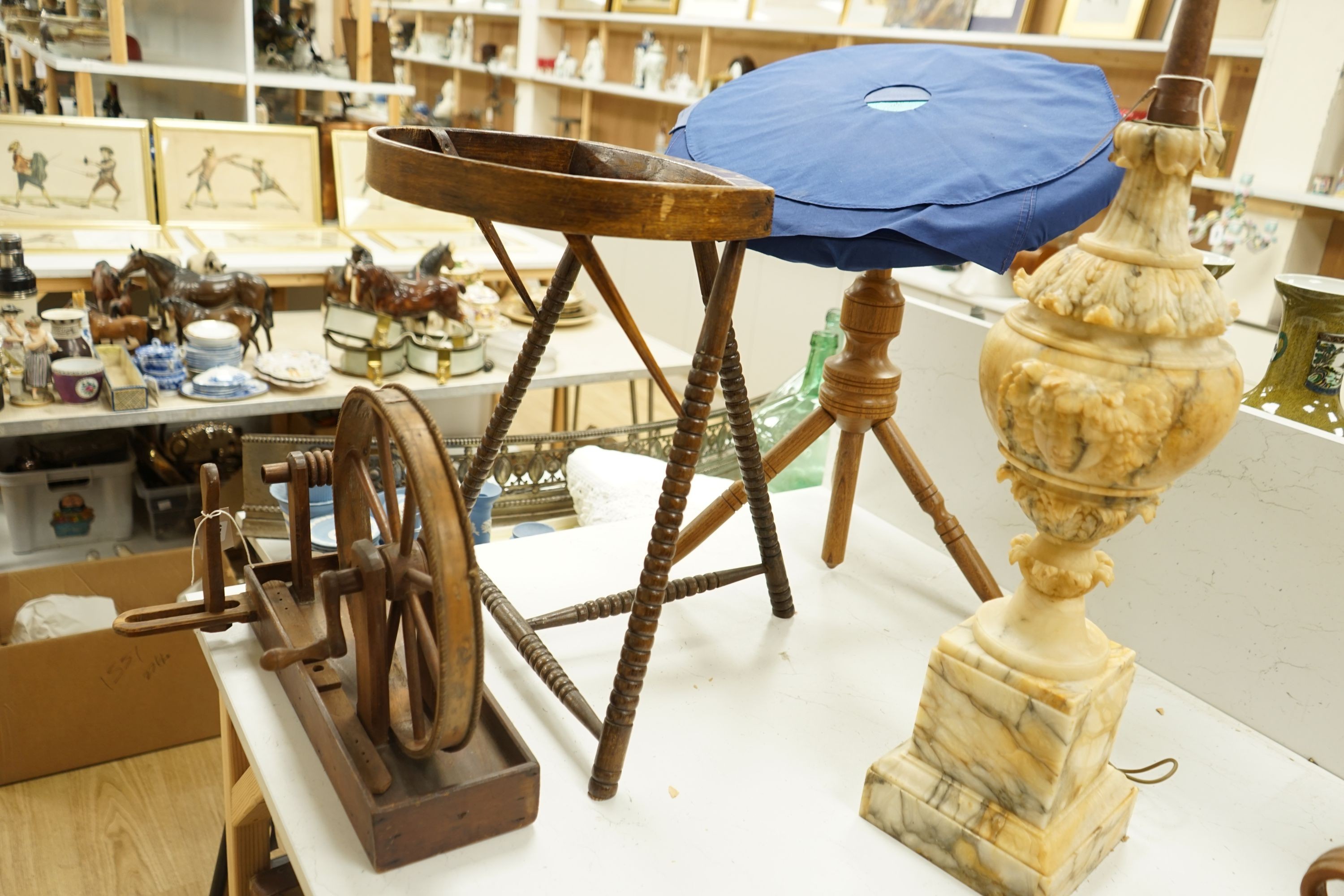 A lace pillow bolster stand, a lace bobbin winder and a lace maker's pillow on tripod stand